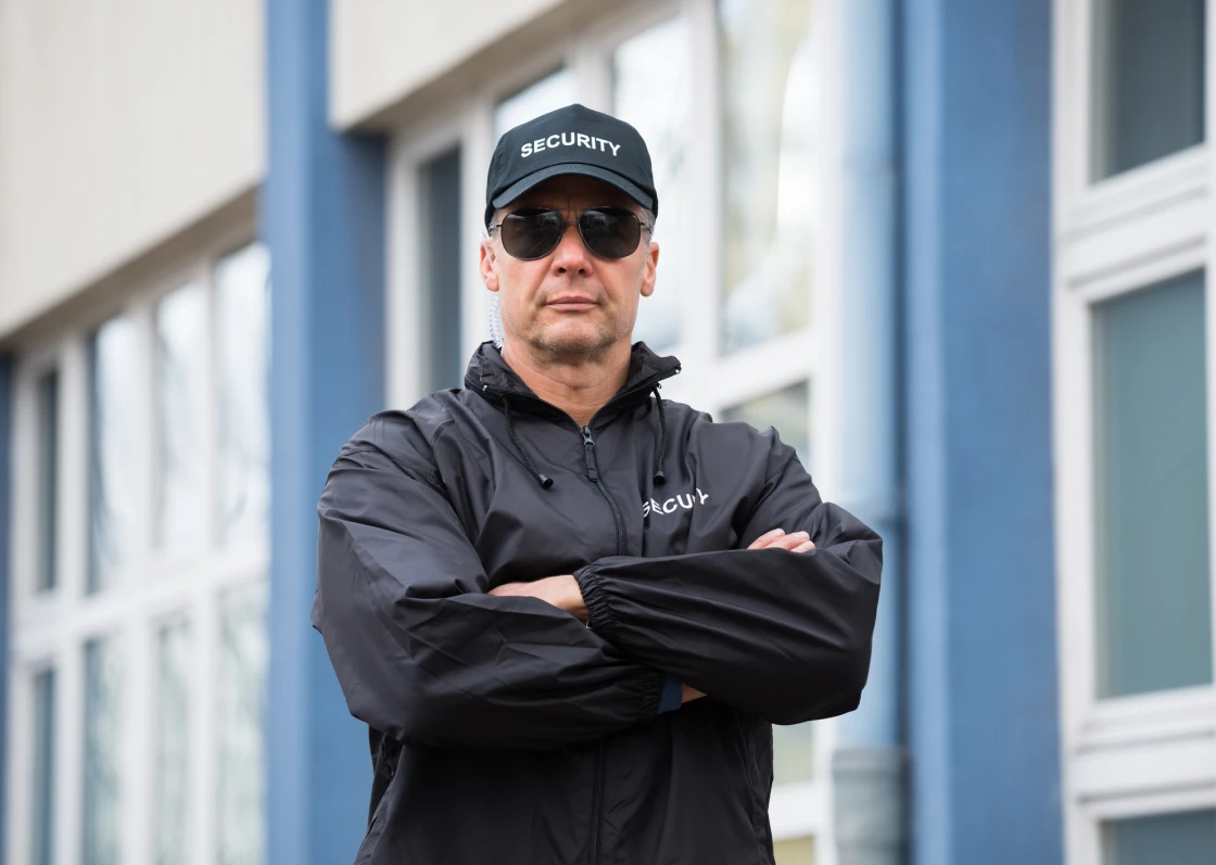 Man with crossed arms and sunglasses