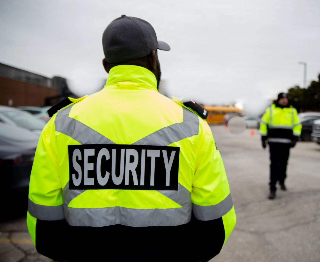 Security guard in bright yellow jacket